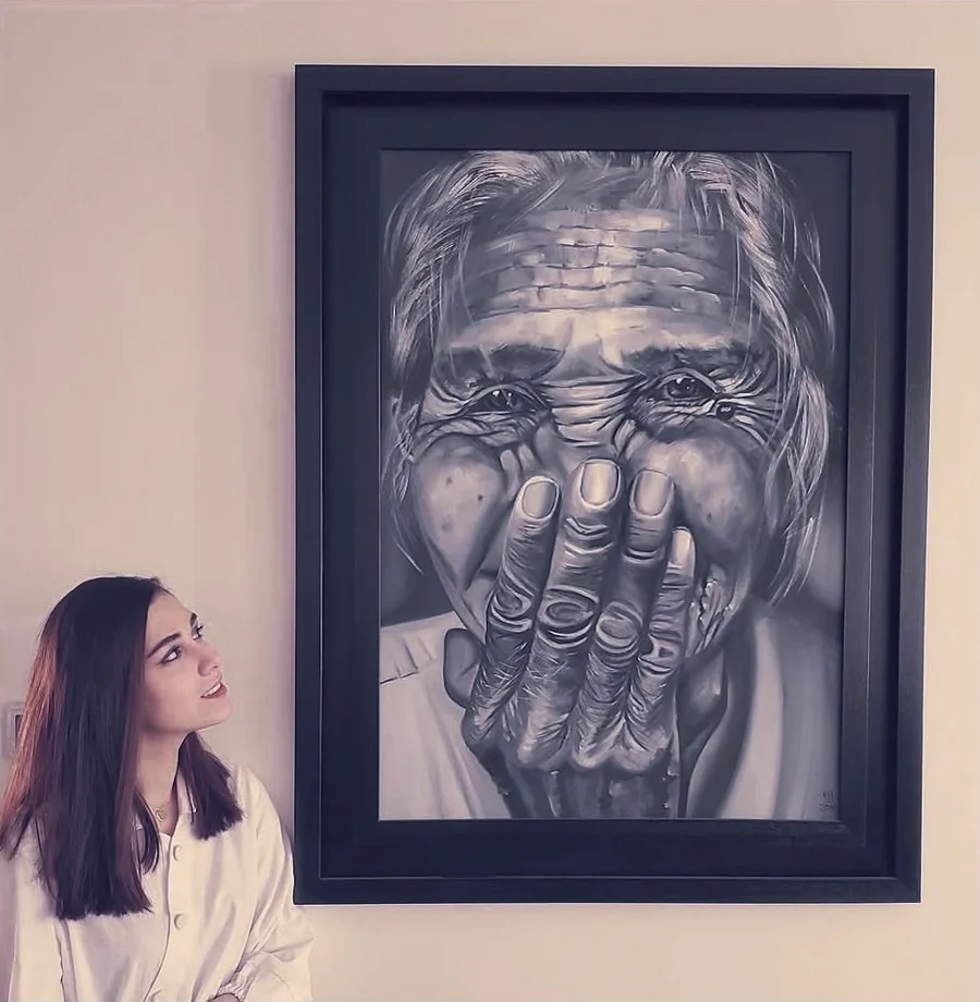 Nava looking up at one of her paintings