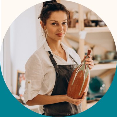 Portrait used for the persona: a woman in an apron holding a ceramic vase in a pottery studio